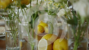 the table at the wedding dinner, which is decorated with real lemons cut in half