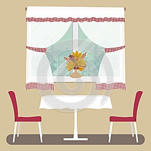 A table with a white tablecloth and two red chairs on a window background