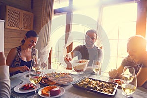 Table with white wine, shrimps, salad and graten