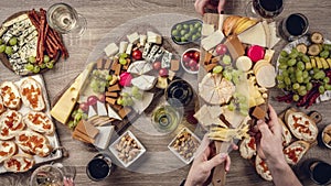 Table with wine appetize and cheese plates, top view. Time lapse,