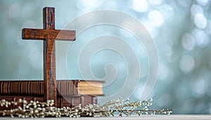 A table with a wooden cross biblical books and delicate willow twigs against an abstract light background, palm sunday greetings