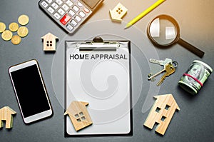 Table with wooden houses, calculator, coins, magnifying glass with the word Home appraisal. The contract for real estate appraisal