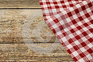 Tablecloth with checkered pattern on wooden table, space for text