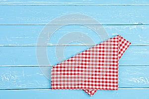 Tablecloth red and white checkerboard pattern on old blue wooden table with copy space