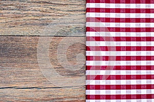 Tablecloth in white and red cage on wooden table
