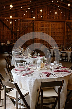 Tables and chairs arranged in a rustic wedding setting