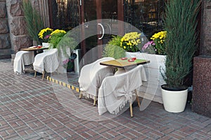Tables and chairs with blankets street cafes