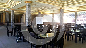 tables and chairs in the hotel dining room in the tourist garden of Tanjung Bajau, Singkawang, West Kalimantan