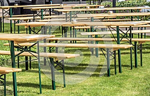 tables and chairs on a lawn to entertain guests outdoors