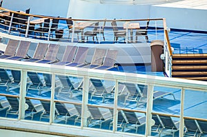 Tables, chairs, and loungers on sun deck of cruise ship