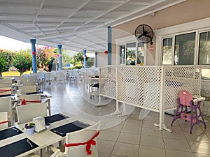 Tables and chairs set decorated in a restaurant cafe bar catering establishment for relaxation in a hotel in a warm tropical