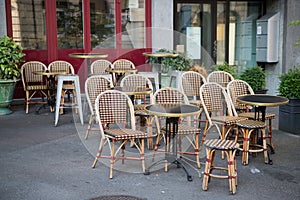 Tables and chairs in street cafe in Europe at morning after party