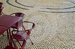 Tables and chairs of a street cafe on a rainy day in Lisbon, Por