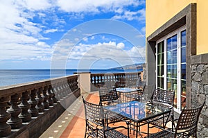 Tables with chairs on sunny terrace, Madeira island, Portugal