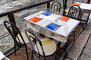 Tables and chairs of traditional outdoor Italian cafe in Florence, cloudy day