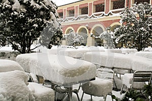 Tables and chairs under deep snow