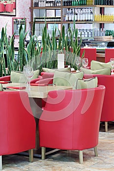 Tables with glasses, armchairs in Japanese restaurant