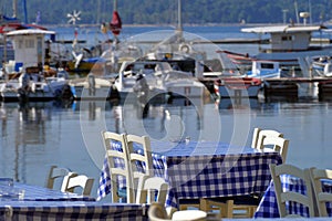 Tables of a restaurant near the sea, very typical in Greece