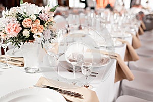 Tables set for an event party or wedding reception. luxury elegant table setting dinner in a restaurant. glasses and