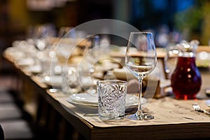 Tables set for an event party or wedding reception. luxury elegant table setting dinner in a restaurant. glasses and dishes. Empty