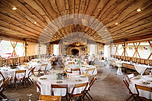 Tables set up in rustic banquet hall for a wedding