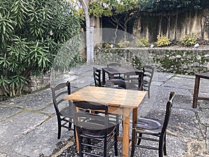Tables with vintage chairs in a pub garden in a medieval village