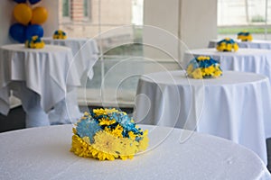 Tables with white tablecloths decorated with flowers photo