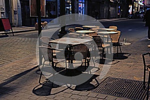 Tables and wicker chairs of an evening street cafe