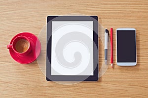 Tablet with blank screen, smart phone on wooden table. Office desk mock up. View from above