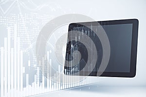 Tablet with blank screen and stock charts interface