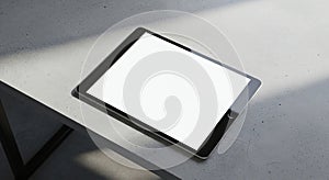 Tablet with Blank White Screen on Concrete Surface in Sunlight