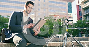 Tablet, city and happy man reading business project, research information and working on online corporate report. Urban
