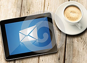 Tablet with coffee on table