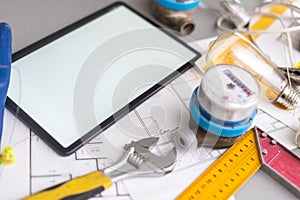 Tablet computer with architecture and construction tools and blueprints.