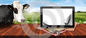 Tablet Computer with Blank Pages and a Cow Looking at the Camera