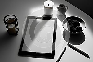 Tablet computer with blank screen on table in black and white tone