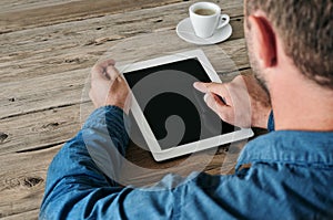 Tablet computer in men hands. Man presses on the blank screen tablet computer