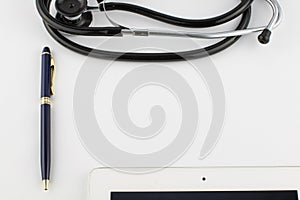 Tablet computer, metal gold-blue pen and stethoscope on a white background copy space
