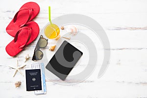 Tablet computer and passport on wood background