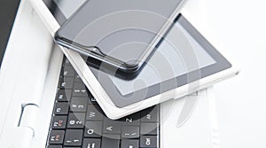 Tablet computer, smartphone on the laptop keyboard