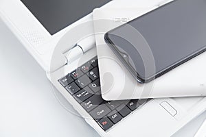 Tablet computer, smartphone on the laptop keyboard