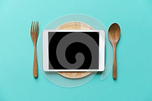 Tablet device served on wood plate