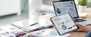 The tablet displaying data analytics alongside a modern office workspace..AI generated image