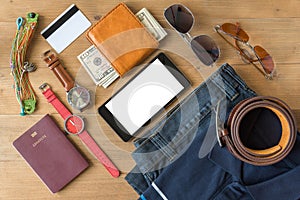 Tablet and flat lay of men`s casual fashion on white wooden floo