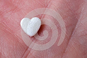 The tablet in the form of heart lay on the hand