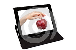Tablet with the hand and a red apple the screen