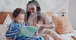 Tablet, happy and mother with child on bed networking on social media, app or internet. Smile, bonding and African mom