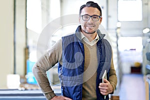 Tablet, happy and portrait of man in factory for manufacturing, networking and inventory. Distribution, industrial and