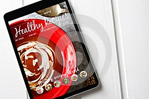 Tablet With healthy recipes blog on screen. web with nutritious