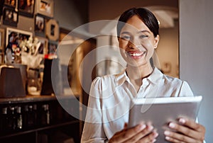 Tablet, management and coffee shop with a woman small business owner or entrepreneur working in her cafe. Portrait